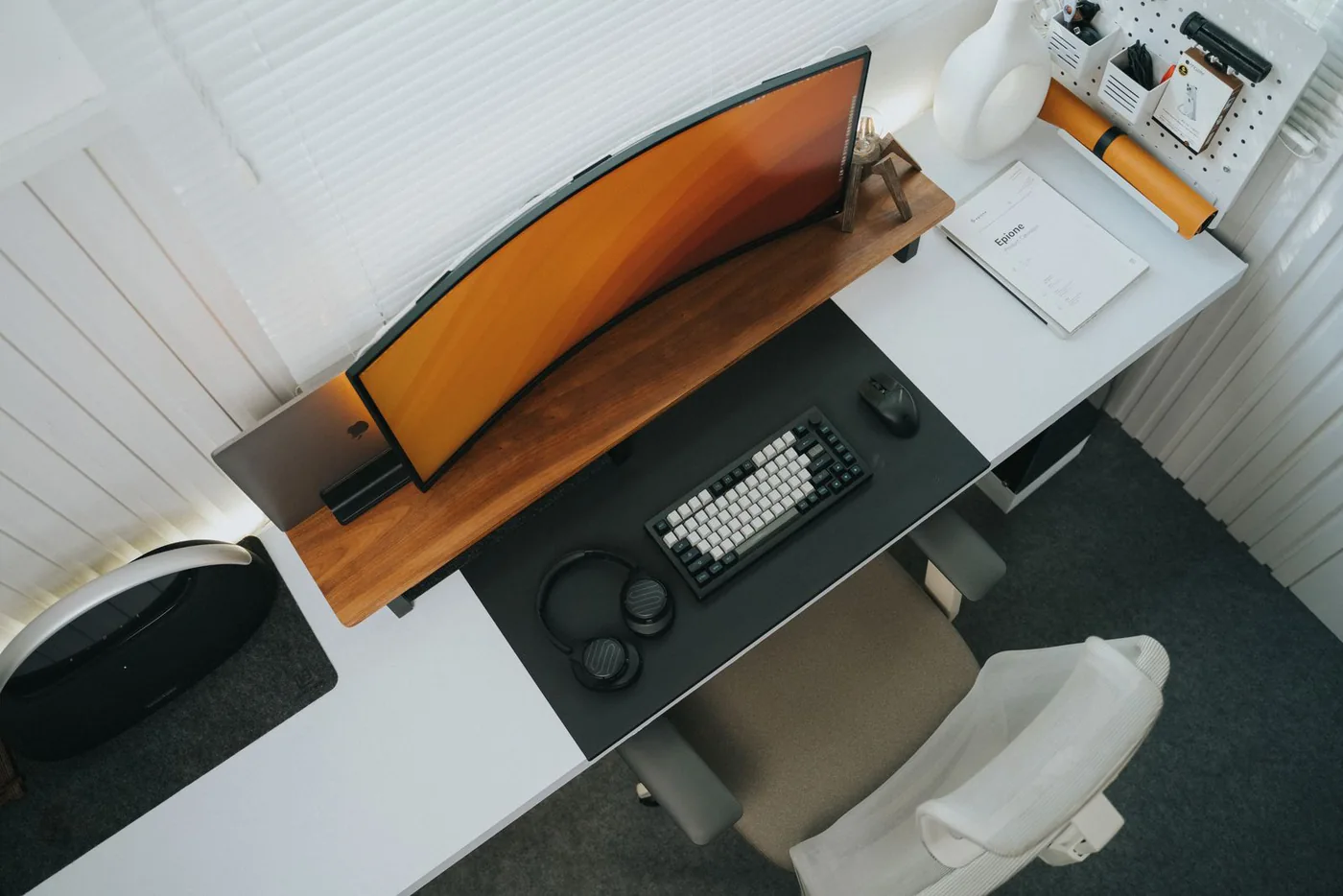 Overhead view of a keyboard, monitor and accessories arranged on a desk