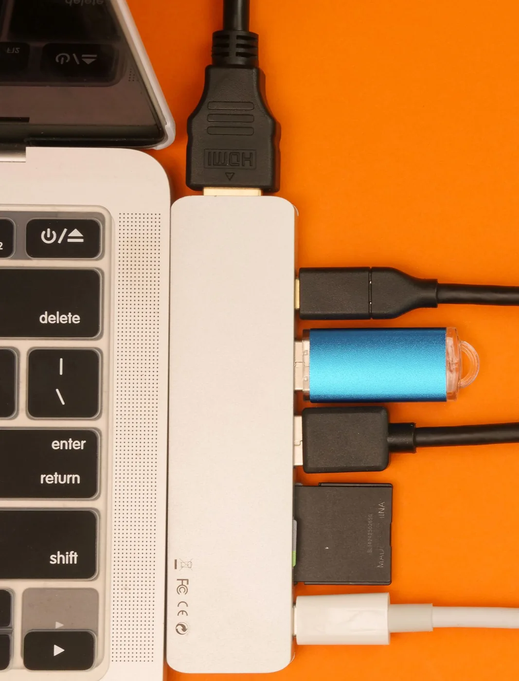 USB hub connected to a laptop with several cables attached